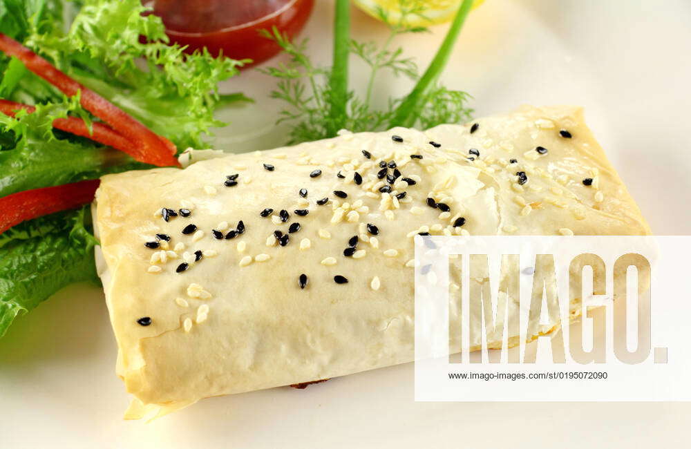 Fresh baked vegetarian carrot and feta filo rolls ready to serve