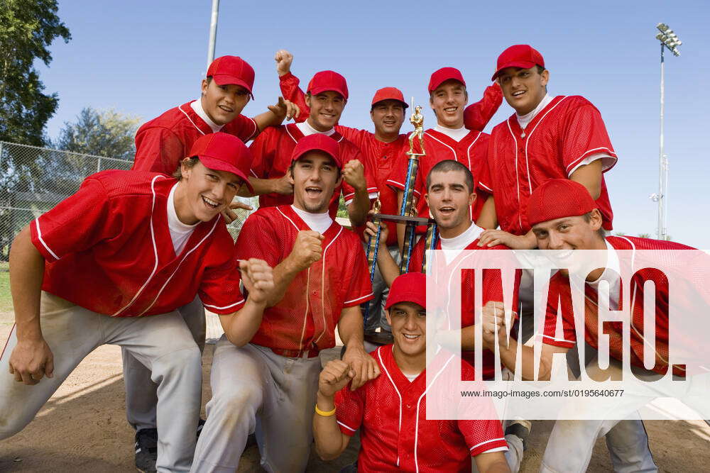 Baseball team-mates holding trophy on field, model released, property ...