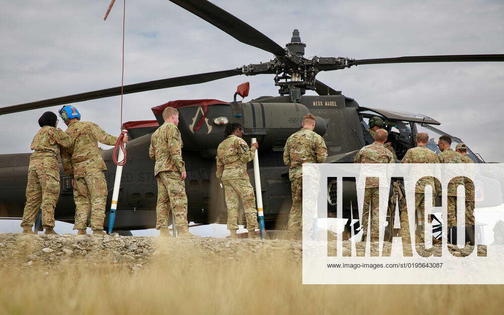 U.S. Army Soldiers assigned to the 12th Combat Aviation Brigade load ...