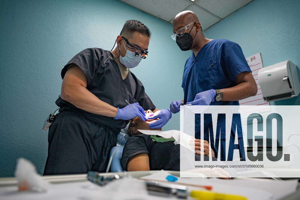 U.S. Air Force Maj. Rondre Baluyot, left, a Dentist assigned to 5th ...