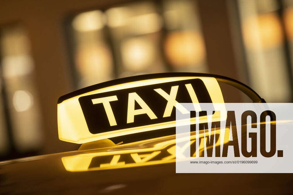 Cab sign glows in the dark, cab drivers waiting for passengers, Munich