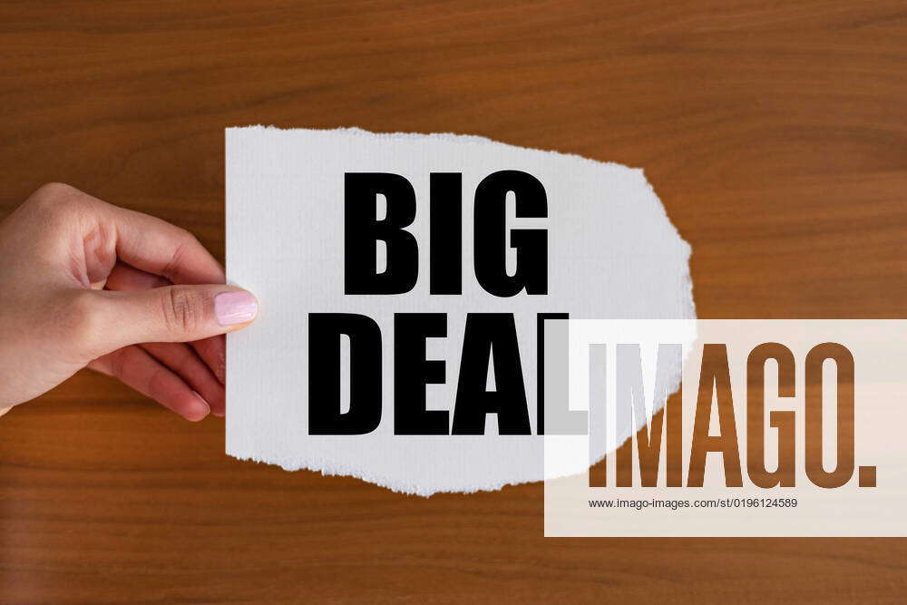 Big deal close up text on the slip. Woman hand holds a piece of paper