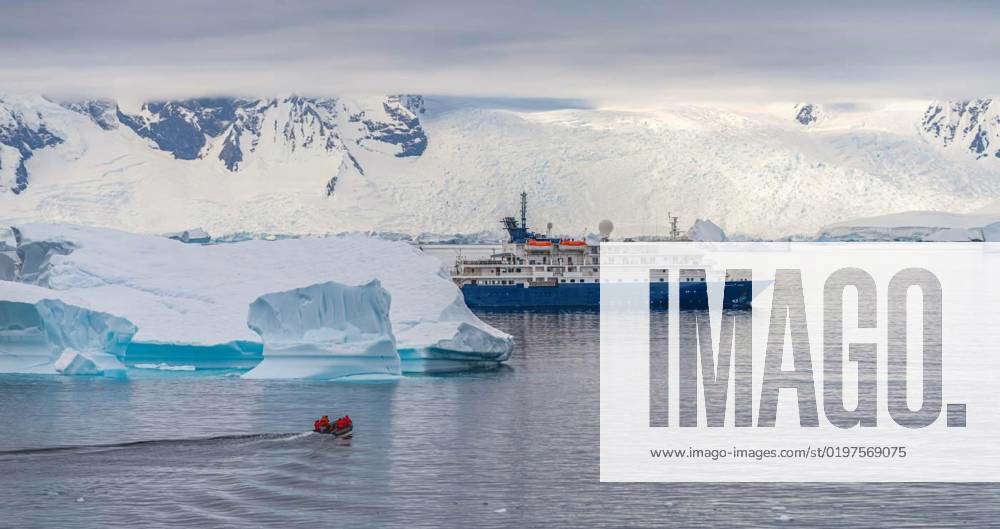 Expedition ship in front of Antarctic iceberg landscape in Cierva Cove ...