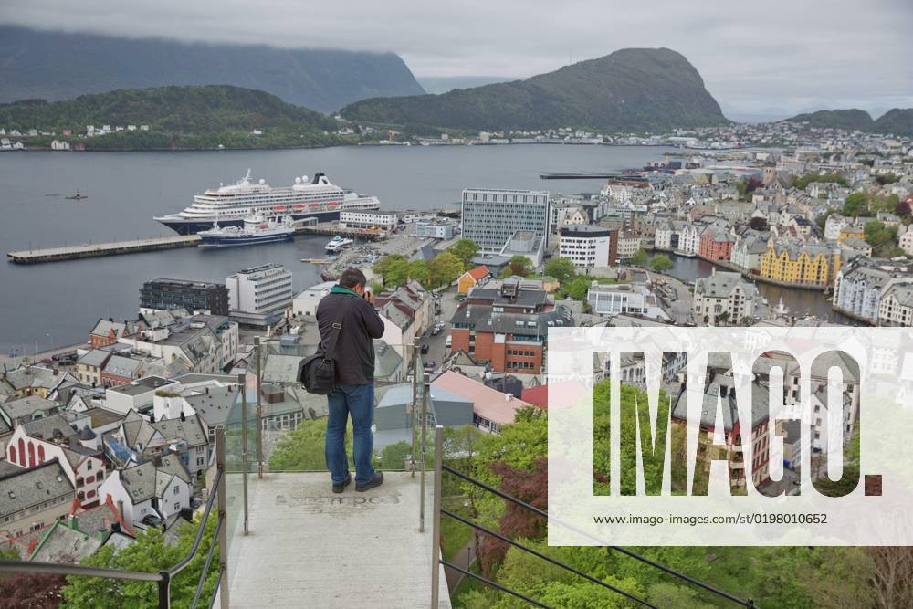 Man Photographing City Of Alesund In Norway From Look Out Point Of 