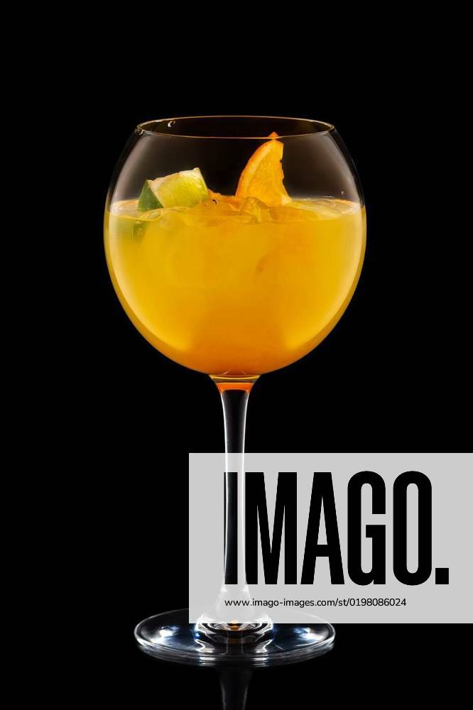 Big round wine glass with fresh cold lemonade isolated on black, Big