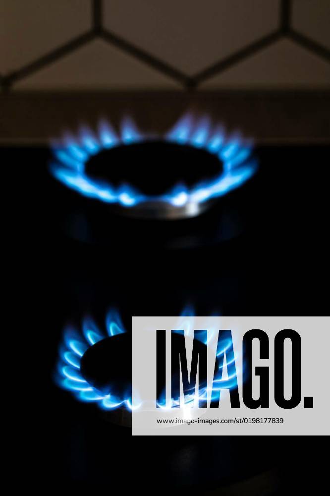 Closeup shot of blue fire from domestic kitchen stove top. Burning gas, gas stove burner. Gas