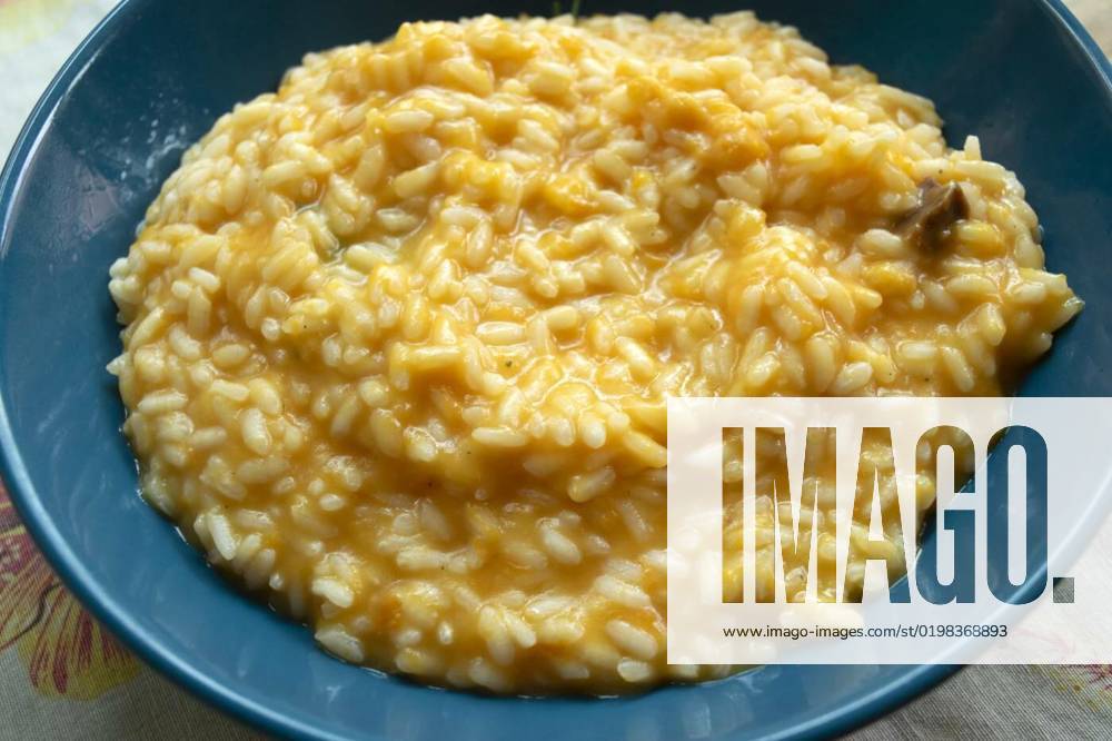 Pumpkin risotto with bacon, pumpkin risotto with roasted bacon in a