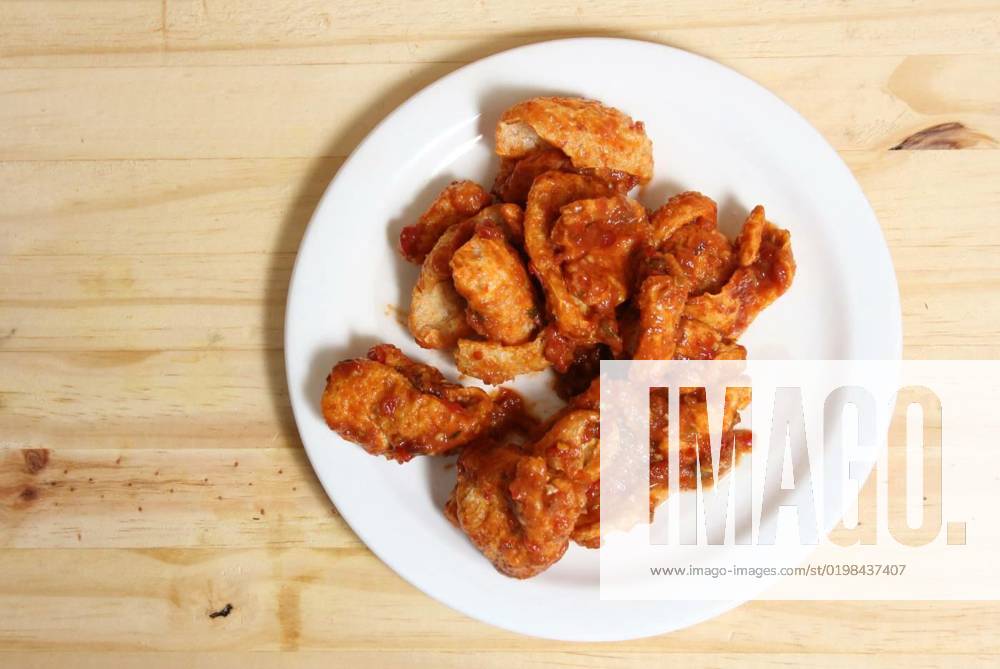 Fried Pork Skins With Red Salsa in Plate on Wooden Table, Fried Pork