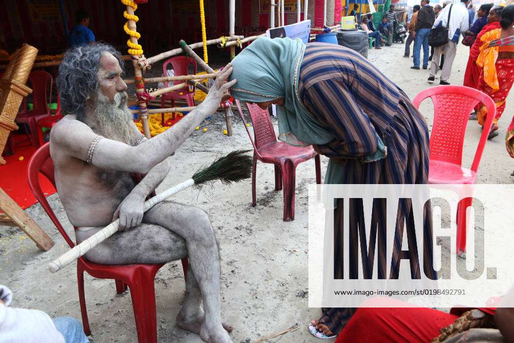 Gangasagar Mela 2023 A Naga Sadhu, or naked Hindu holy man, is blessing a  Muslim woman