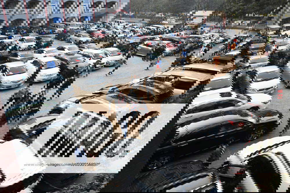 Car Market In Dhaka, Bangladesh Buyers look at reconditioned cars at a