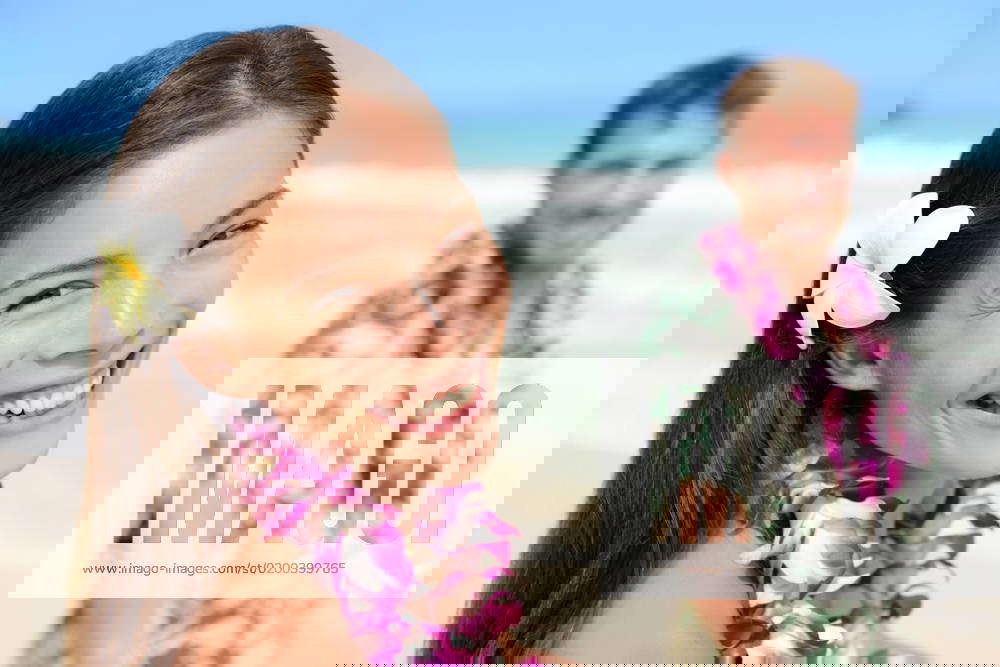 Happy Hawaii couple in Hawaiian lei, flower head and Aloha shirt