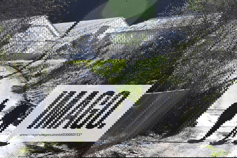 Law enforcement officers walk toward the scene of a mass shooting at Mountain Mushroom Farm in Half