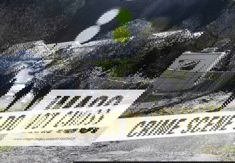 Law enforcement officers walk toward the scene of a mass shooting at Mountain Mushroom Farm in Half