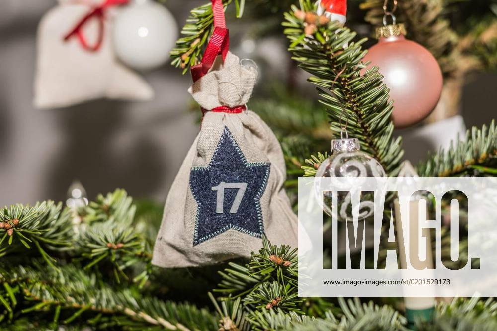 Sacks balls and candles hanging on a christmas tree, sacks with