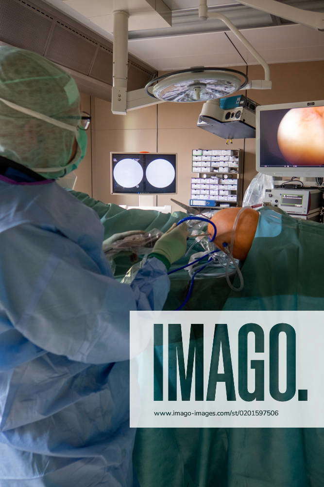 Doctor performs a surgical knee endoscopy in an operating
