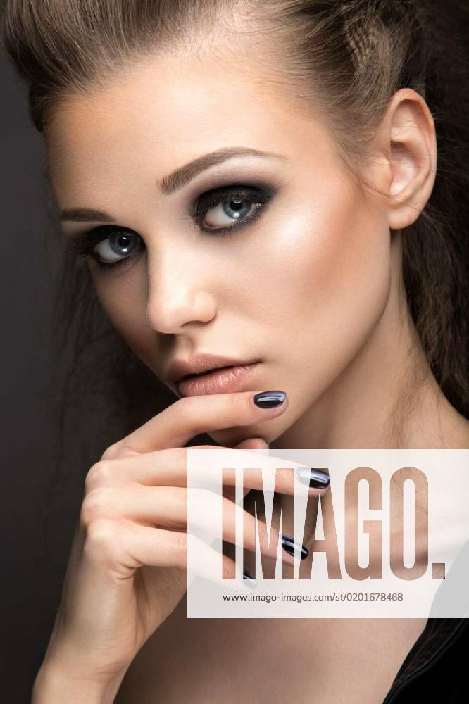 Beautiful girl in leather jacket with bright makeup and manicure Cat s