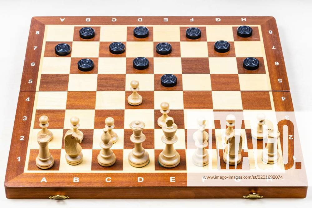 Chessboard with first moves of chess and checkers, playing by different