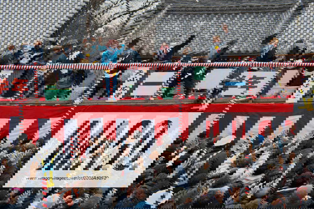 Local celebrities throw beans during the beanthrowing ceremony at