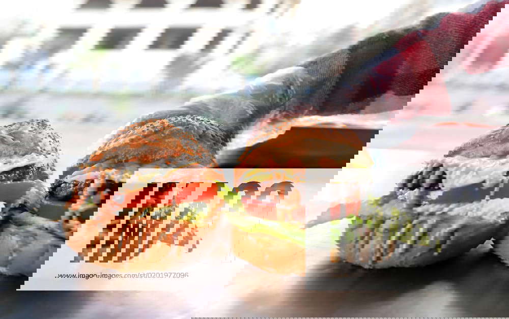 Palestinian woman Amani Shaat, 25, cooks burgers at a stall called