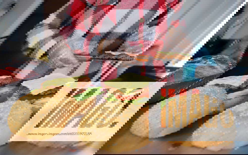 Palestinian woman Amani Shaat, 25, cooks burgers at a stall called