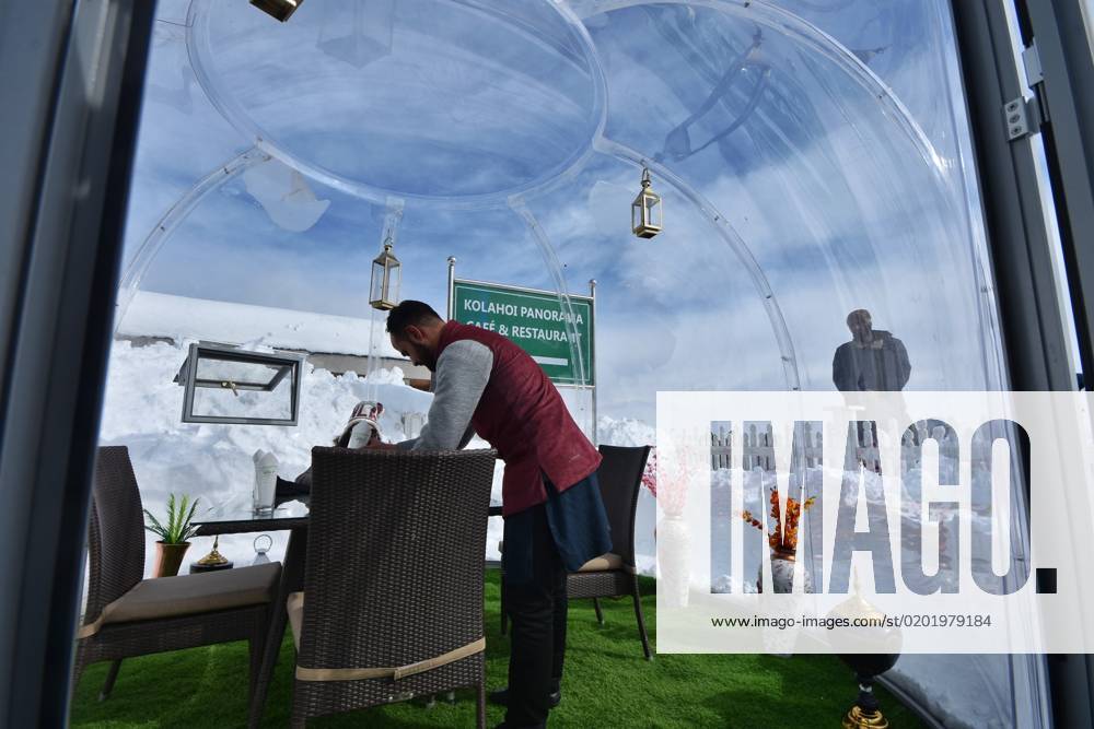 India First Glass Igloo restaurant in Gulmarg, Kashmir Chef serving people in glass igloo restauran
