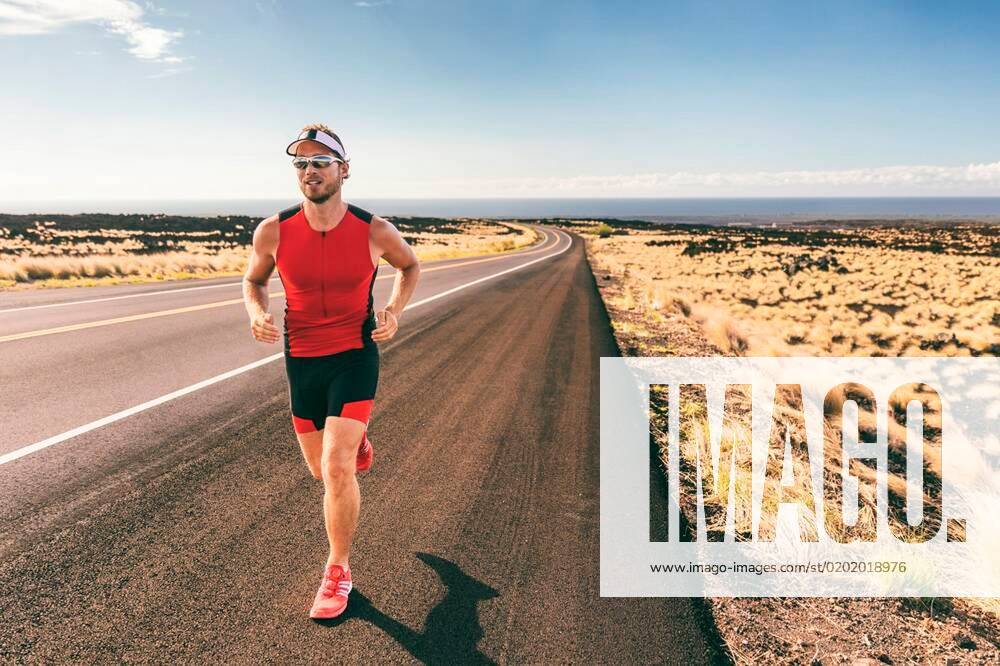 Sport runner man athlete running in triathlon tri suit training for