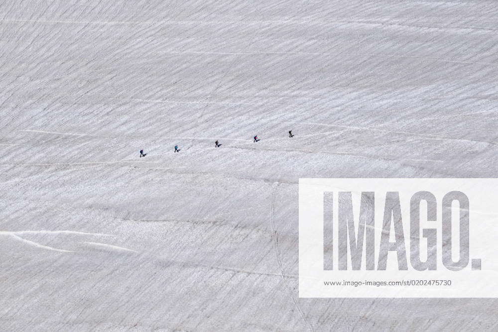 Aerial view of a group of alpinists crossing the slopes of the upper part of the GÃ ant Glacier