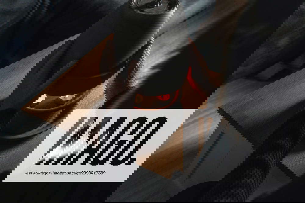 14 October 2022 young man warms himself in a dark apartment by a homemade tea light stove