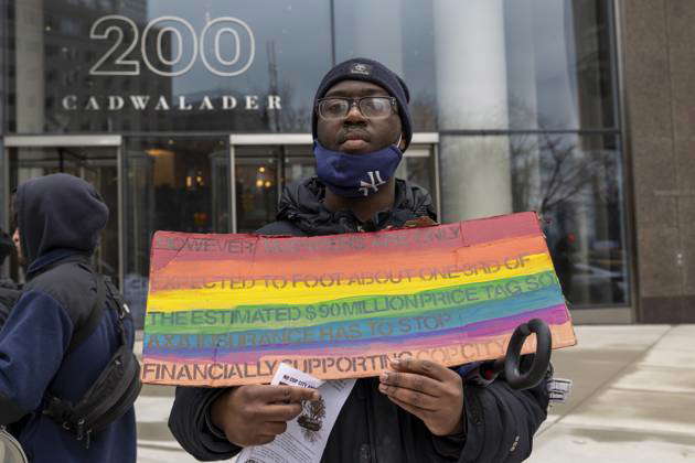 February 27, 2024, New York, New York, USA: A protester holds up his ...