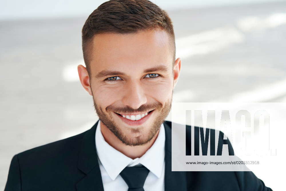 close-up-portrait-of-handsome-smiling-young-man-in-elegant-suit-close