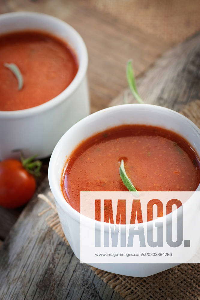Fresh tomato soup with cherry tomatoes and fresh herbs and copyspace