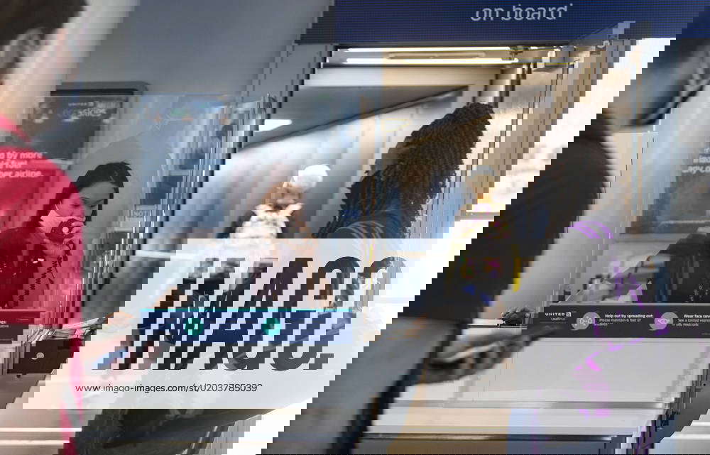 February 22, 2023, USA A United Airlines gate agent helps passengers