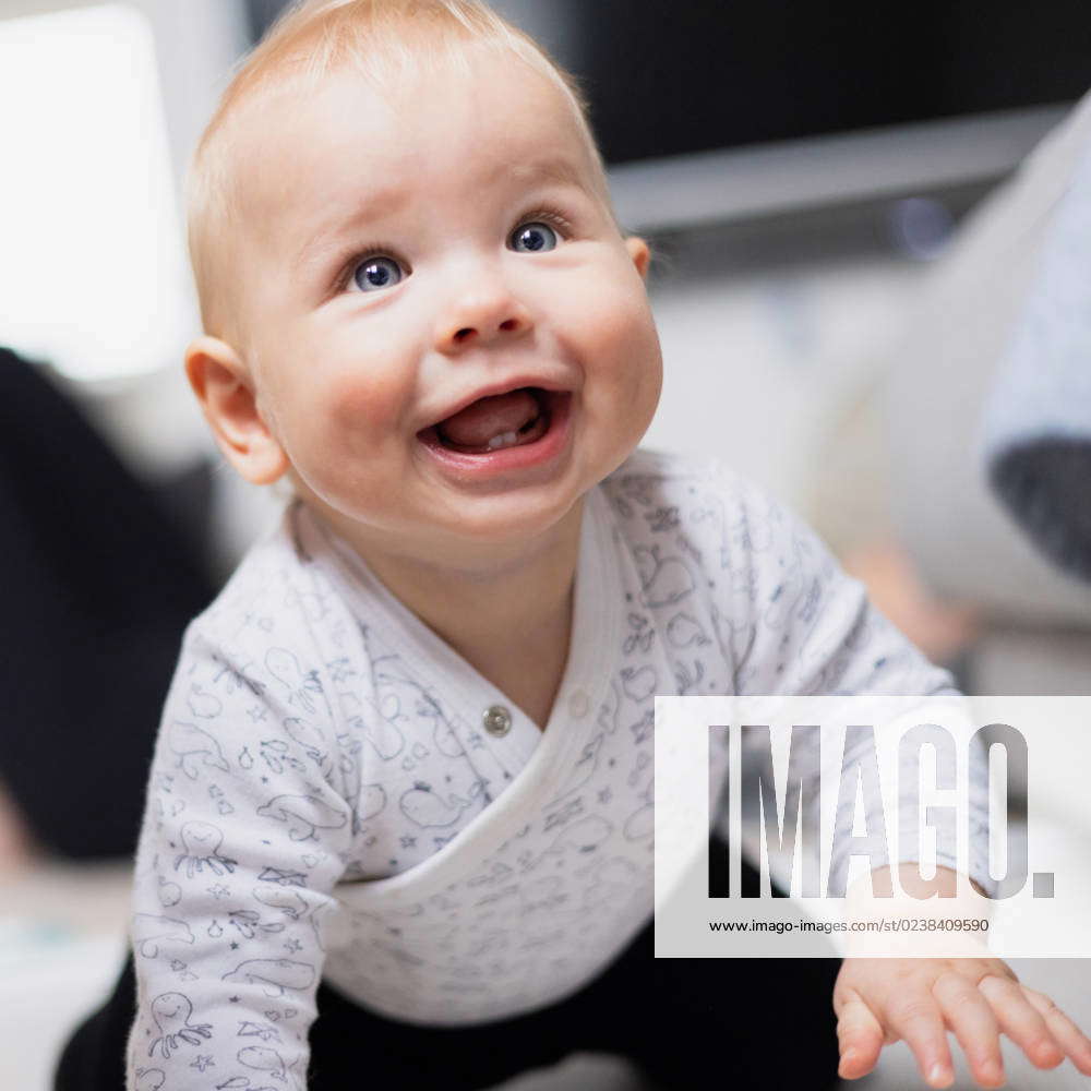 cute-infant-baby-boy-playing-crawling-and-standing-up-by-living-room