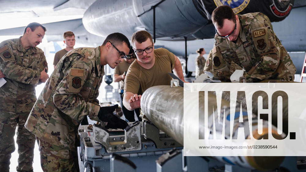 Airmen from the 2nd Munitions Squadron assemble an inert munition ...