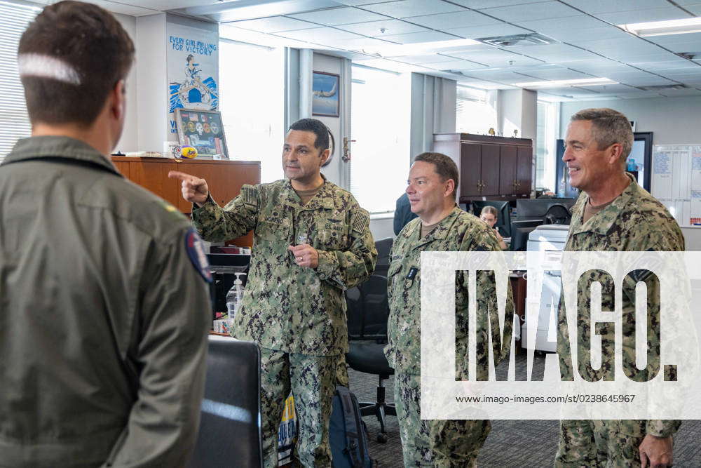 Chief of Naval Personnel Vice Adm. Rick Cheeseman, center, is given a ...