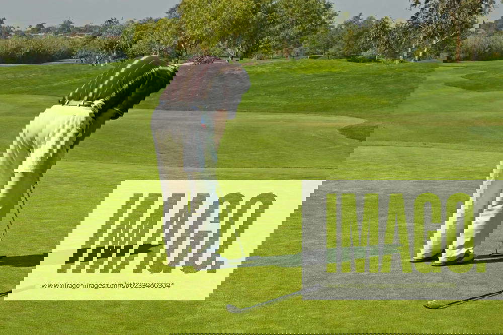 Golf course action and players hitting the greens