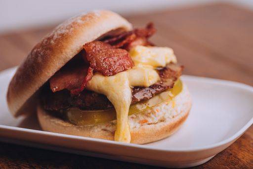 A closeup of a freshly cooked hamburger topped with melted cheese and ...