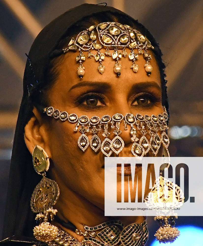 FILE- In this June 22, 2012 file photo, an Indian model poses with Tanishq  jewelry at an event in Kolkata, India. The popular Indian jewelry brand has  withdrawn an advertisement featuring a