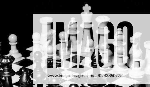 A grayscale of a chessboard with chess pieces placed on it, ready for a ...