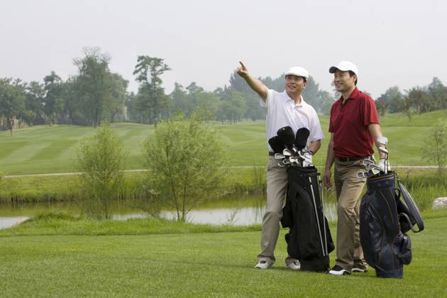 Two Chinese golfers pointing forward Beijing China