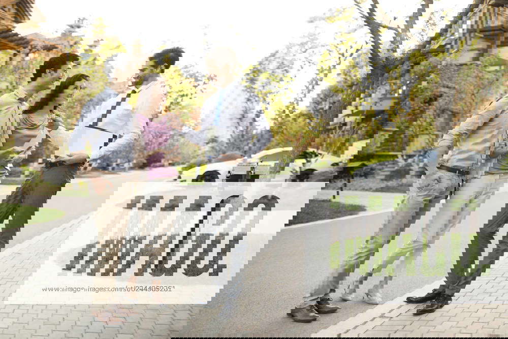 Real estate agent giving young Chinese couple house key Beijing China