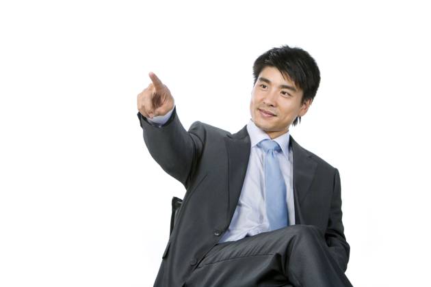 Young Chinese businessman pointing by finger Beijing