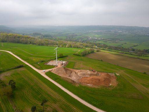 An aerial view of a vast expanse of land with T-pylons to connect a ...