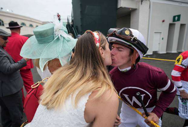 Syndication: USA TODAY Cassidy Gaffalione kisses her husband, jockey Tyler  Gaffalione, before an