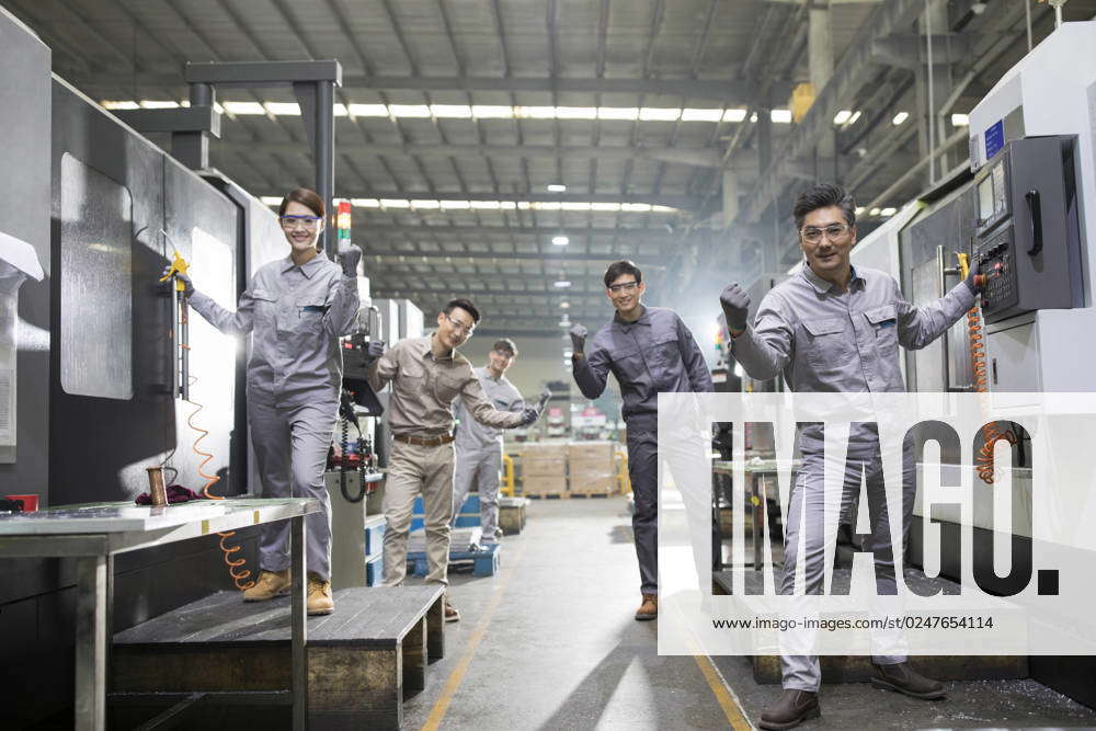 Confident Chinese engineers in the factory Beijing