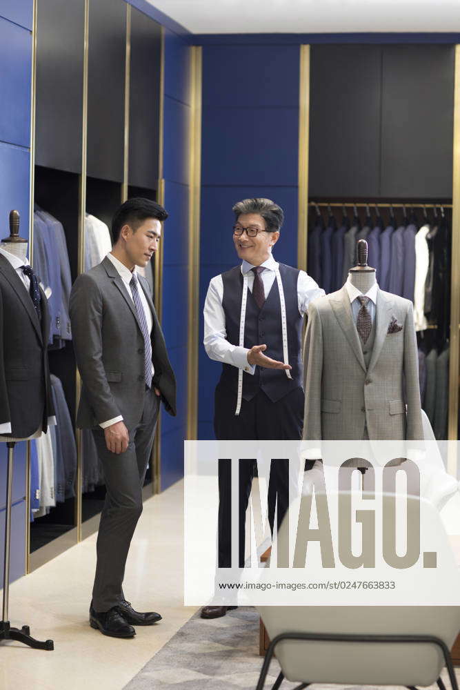 Chinese Fashion Designer Showing Customer Business Suit Beijing China