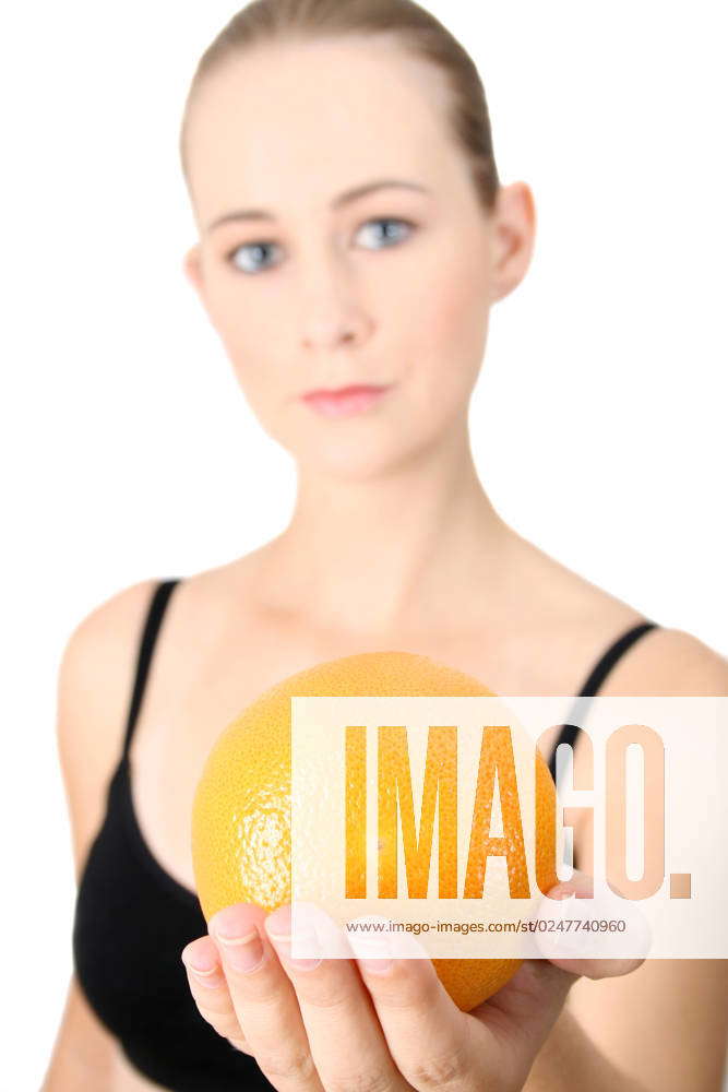 Model holding an orange in her hand. FOCUS ON ORANGE