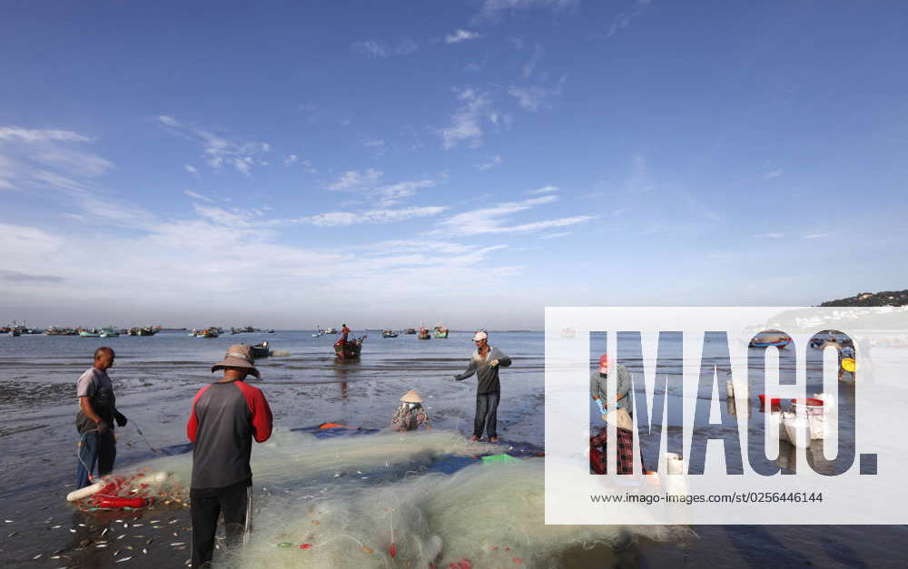 Fishermen repairing fishing nets. Hang Dua bay. Vung Tau. Vietnam