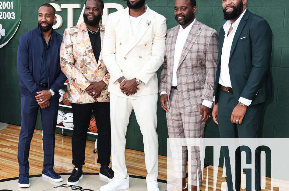 NBA basketball player LeBron James, third from right, poses with his high  school basketball coach and teammates, from left, Dru Joyce II, Lil' Dru  Joyce III, Sian Cotton, Willie McGee and Romeo Travis at the premiere of  the Peacock film Shooting Stars