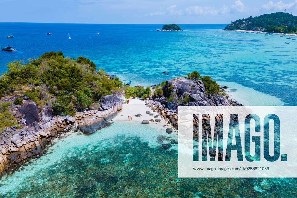 Couple with a kayak on a small Island in front of the Island Ko Lipe ...